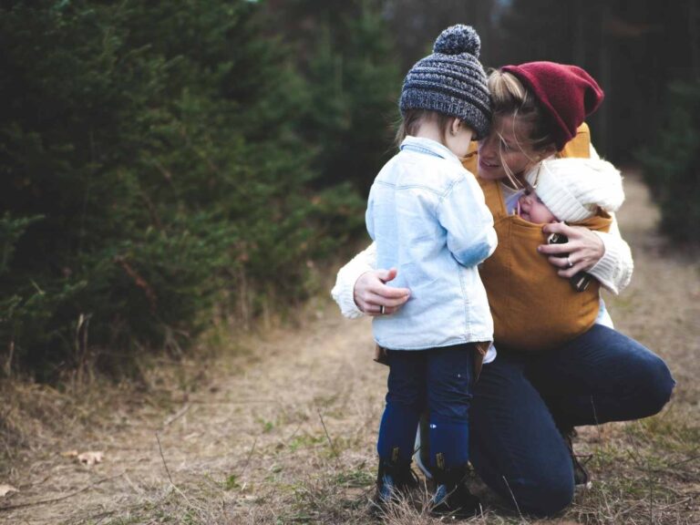 mother hugging kids