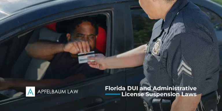 A driver handing over their license to a police officer, illustrating an administrative license suspension process.